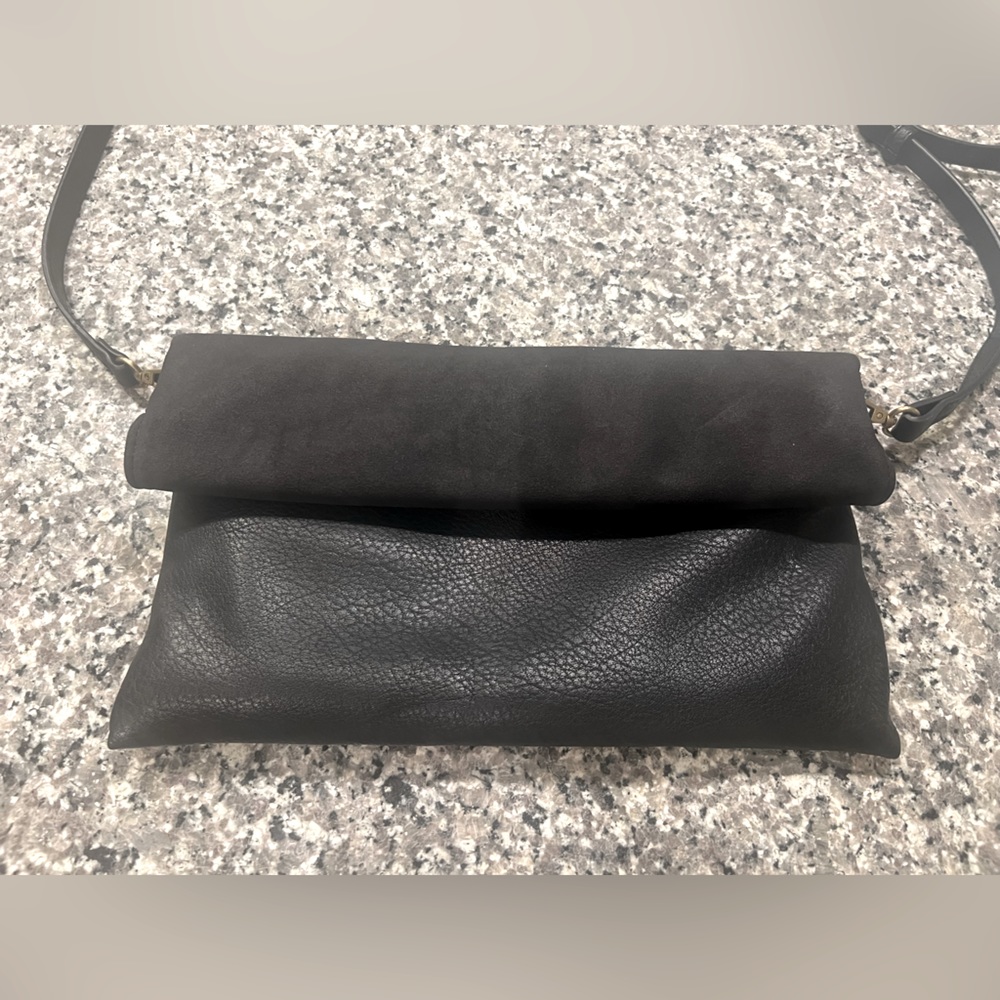 Anthropologie black leather purse with magnetic close.